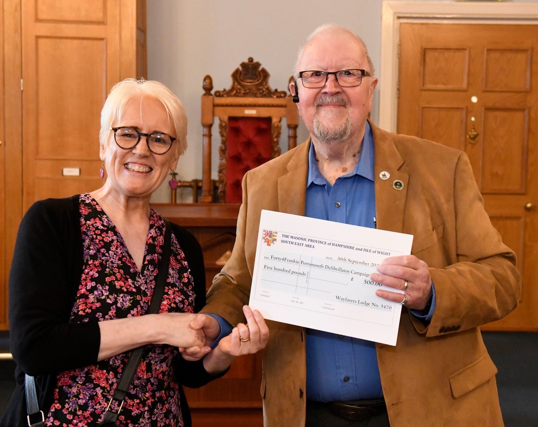Roger presenting a cheque to Lynn